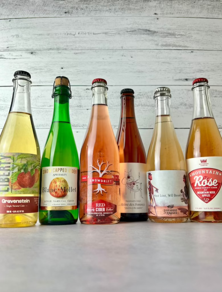 Six bottles of 500 mL and 375 mL ciders, including: Liberty Ciderworks, Snowcapped Cider, Snowdrift Cider, Bauman's Cider, Botanist & Barrel, and Whitewood Cider