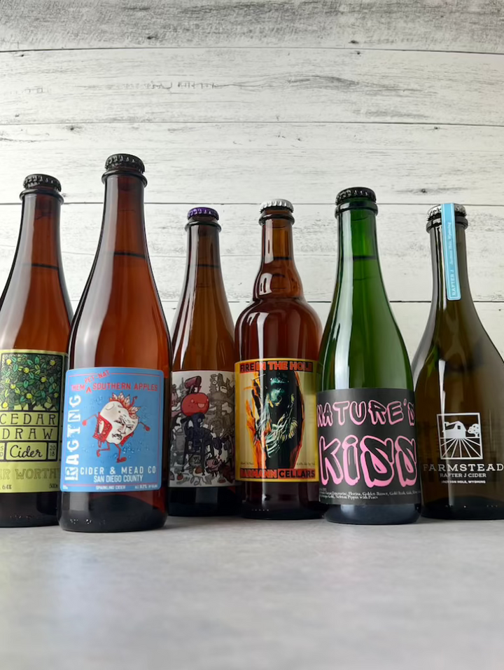 Six bottles of 500 mL and 375 mL cider, including ciders from: Cedar Draw Cider, Raging Cider & Mead, Two Broads Cider, Barmann Cellars, Botanist & Barrel, and Farmstead Cider