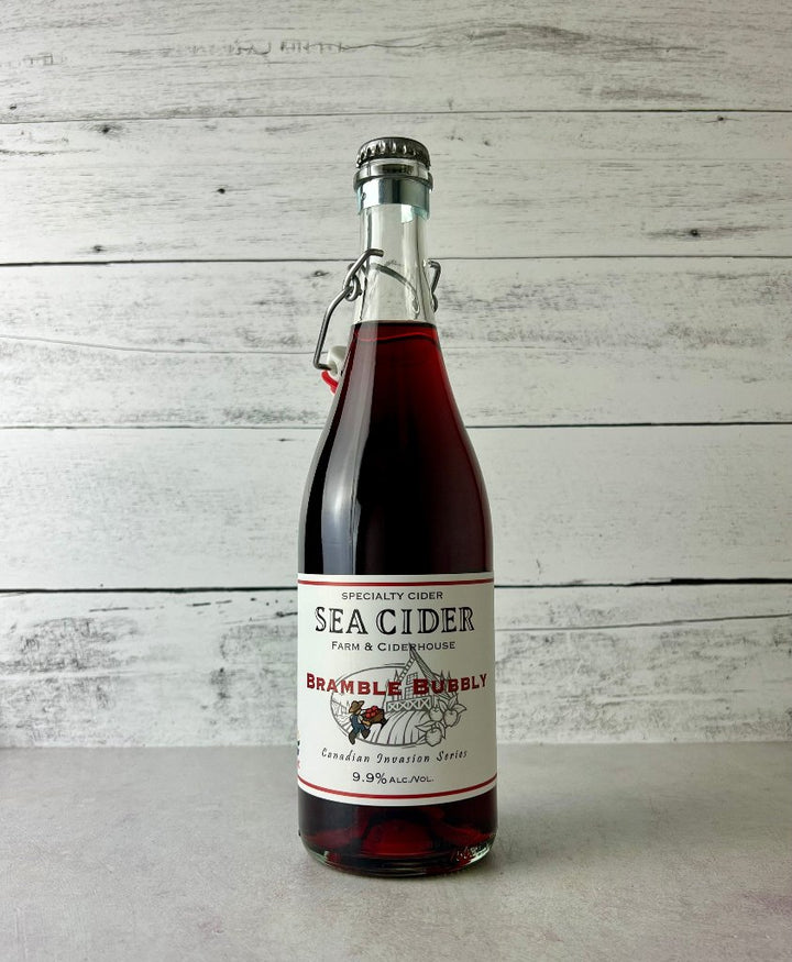 750 mL clear glass bottle of dark pink Sea Cider Farm & Ciderhouse Bramble Bubbly cider