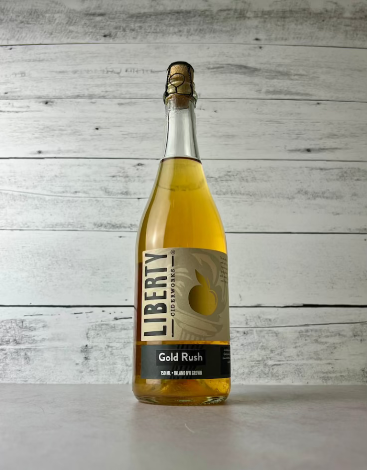 750 mL bottle of Liberty Ciderworks Gold Rush cider w/cork and cage